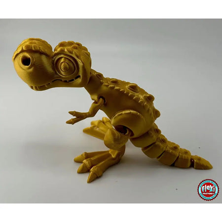 Golden, articulated dinosaur toy.