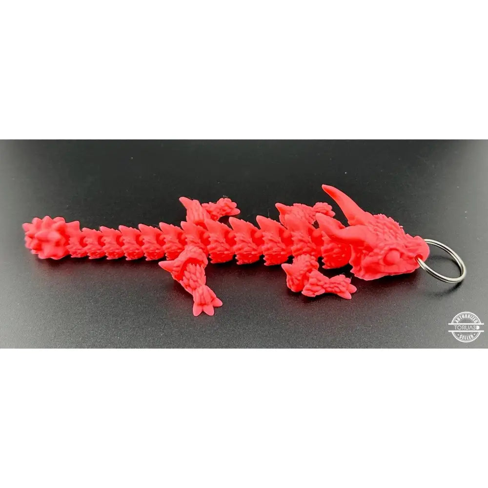 Red articulated dragon keychain.