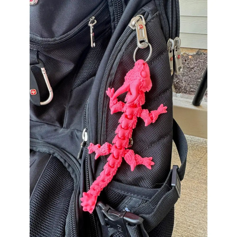 Pink articulated lizard keychain.