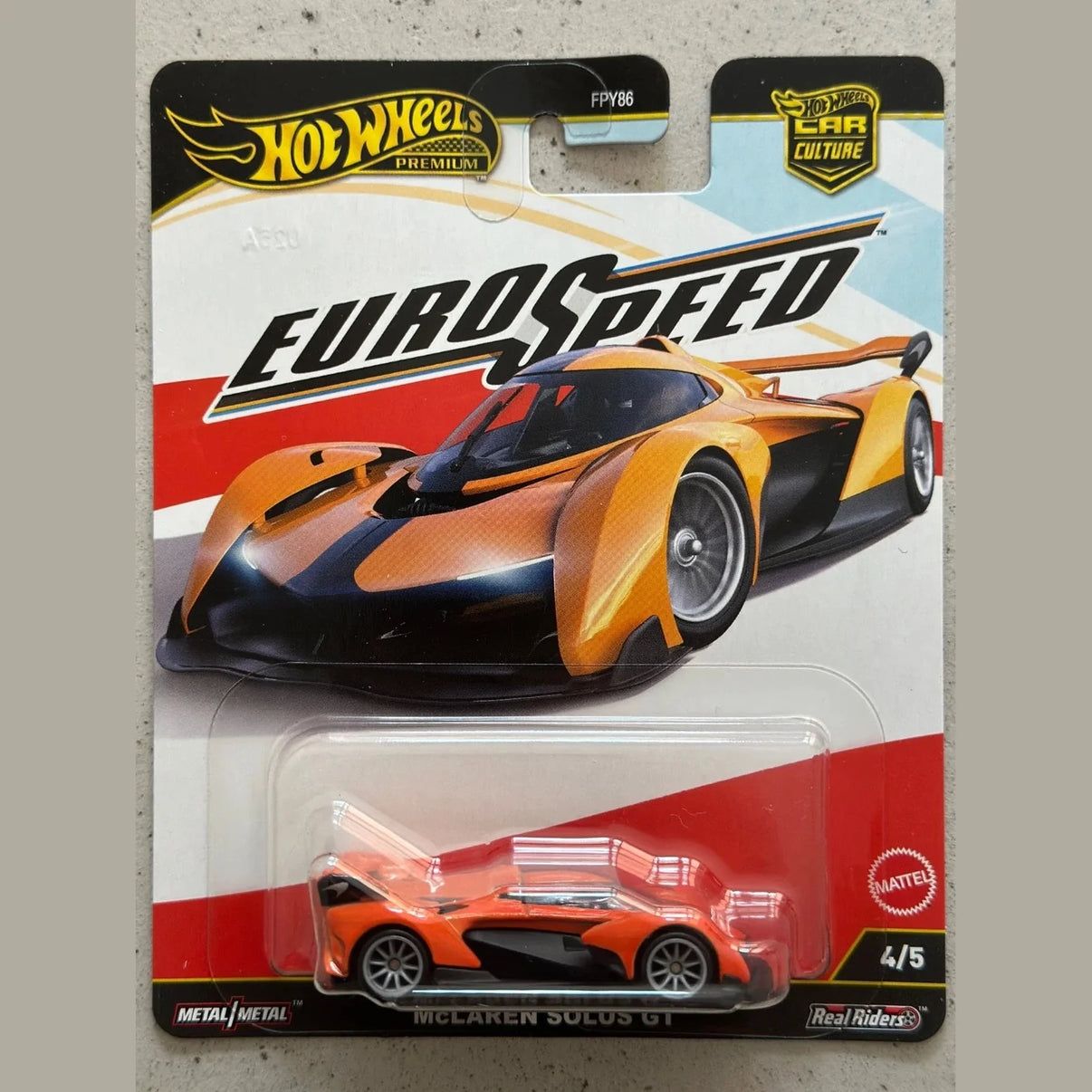 Hot wheels mclaren solaus gt toy car in orange and black, metal body with detailed design.
