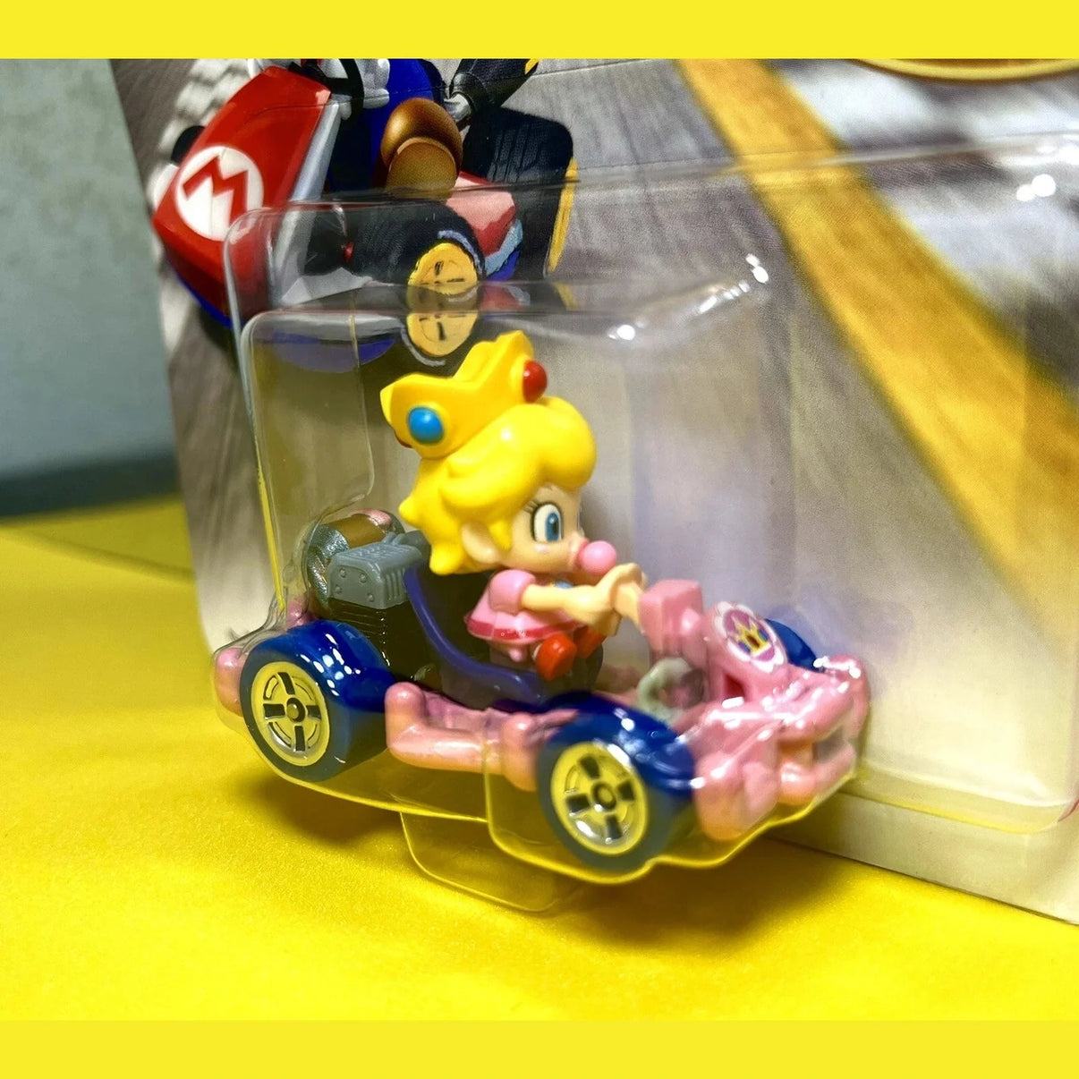 Mario kart peach figure in clear plastic packaging.