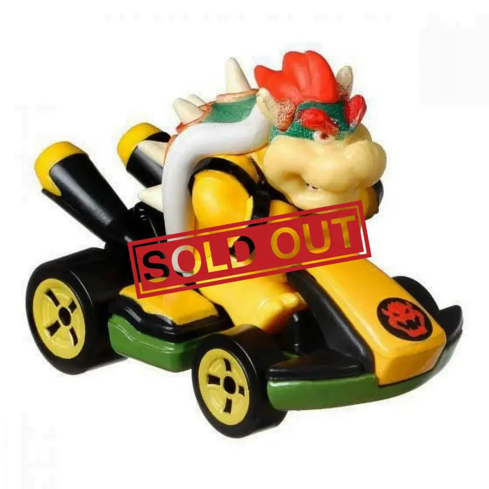 Bowser from Mario Kart in his yellow kart with black wheels and green trim.