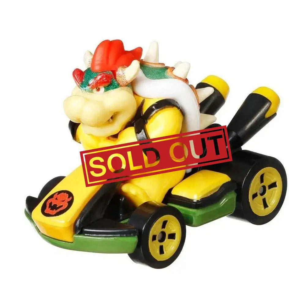 Bowser in a yellow and black Mario Kart toy car.