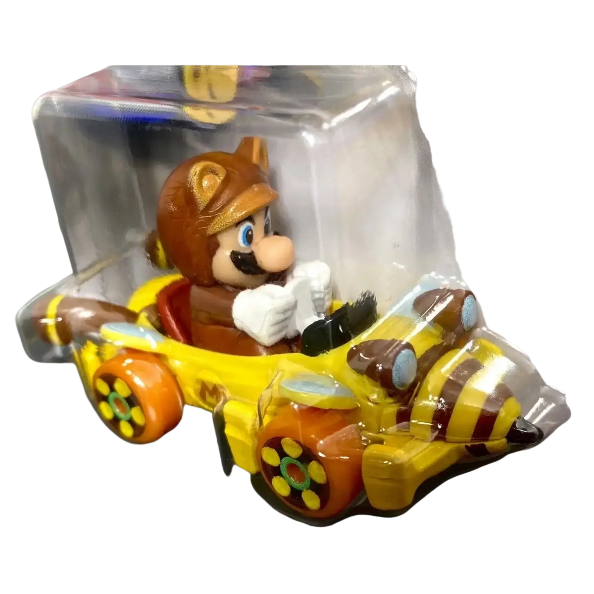 Yellow and brown mario kart toy car with clear plastic packaging.