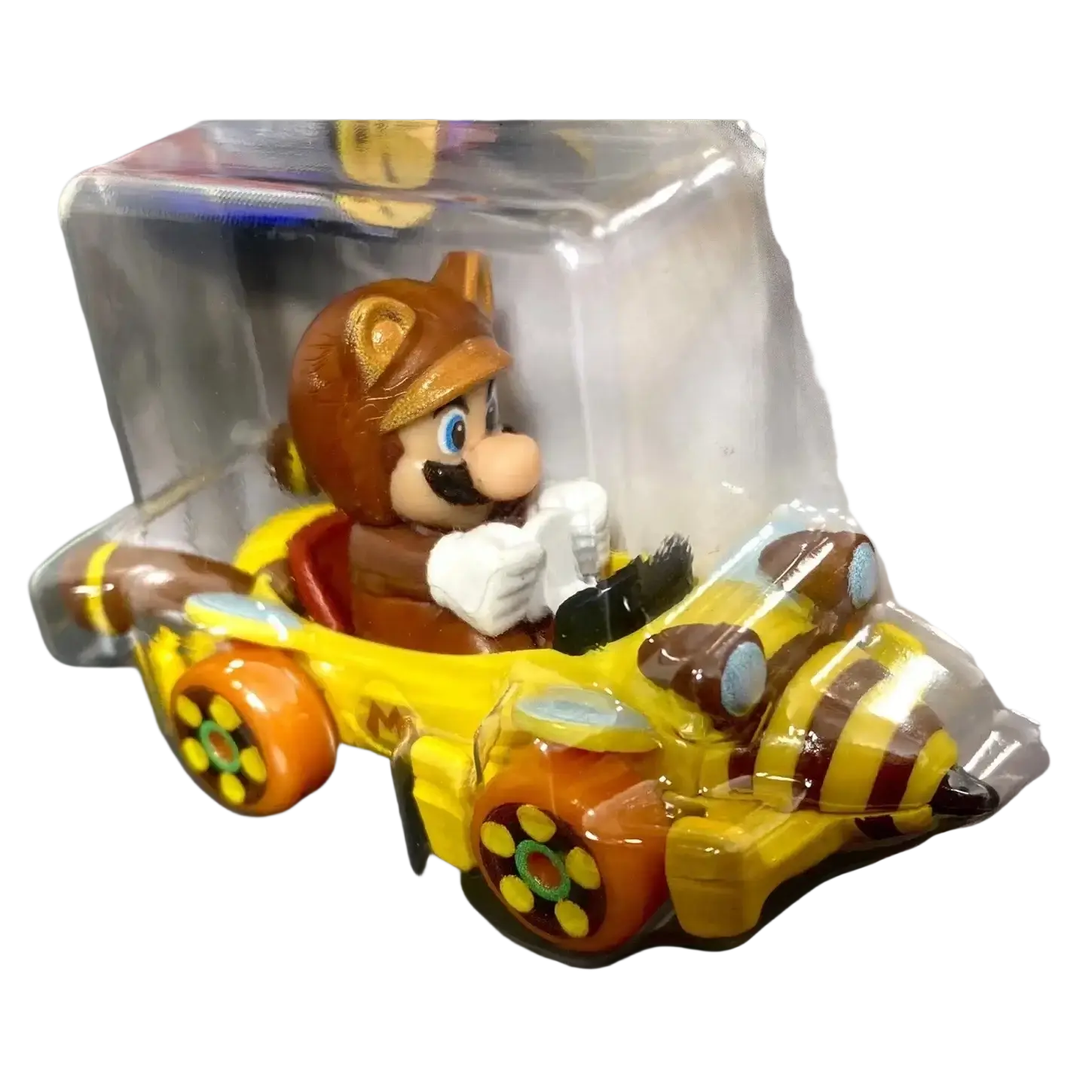 Yellow and brown mario kart toy car with clear plastic packaging.