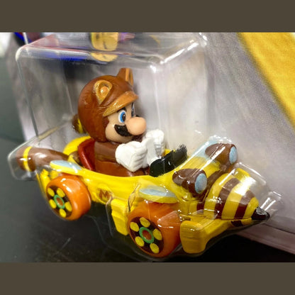 Yellow and brown mario kart toy car with clear plastic packaging.