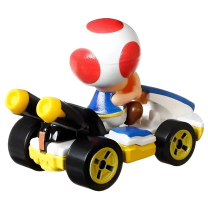A Toad character from Mario Kart in a white, blue, and yellow racing kart.
