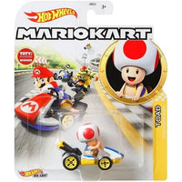 Yellow and blue kart with a red-and-white mushroom cap toad figure seated inside, packaged in a hot wheels mario kart blister pack.