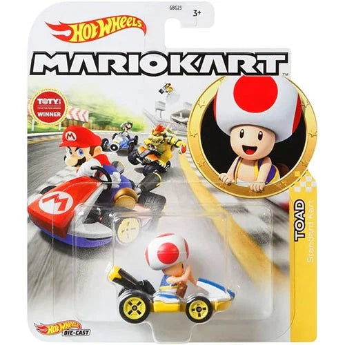 Yellow and blue kart with a red-and-white mushroom cap toad figure seated inside, packaged in a hot wheels mario kart blister pack.