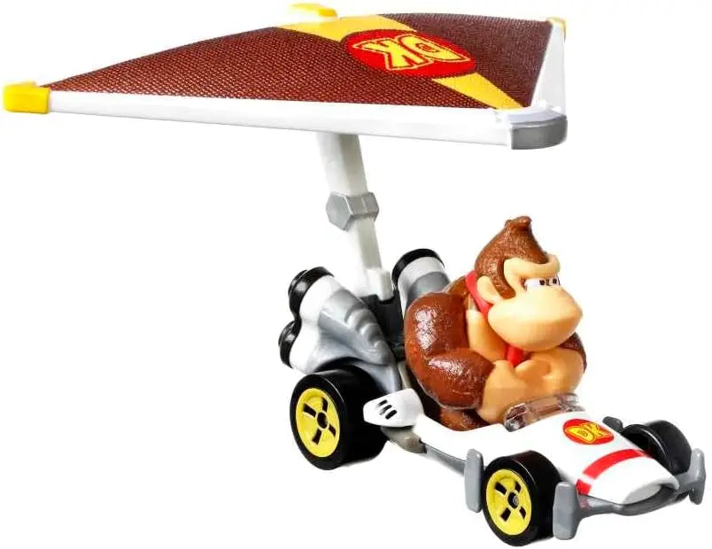 Donkey kong in a white and red hot wheels mario kart racing kart with yellow wheels and dk logo canopy