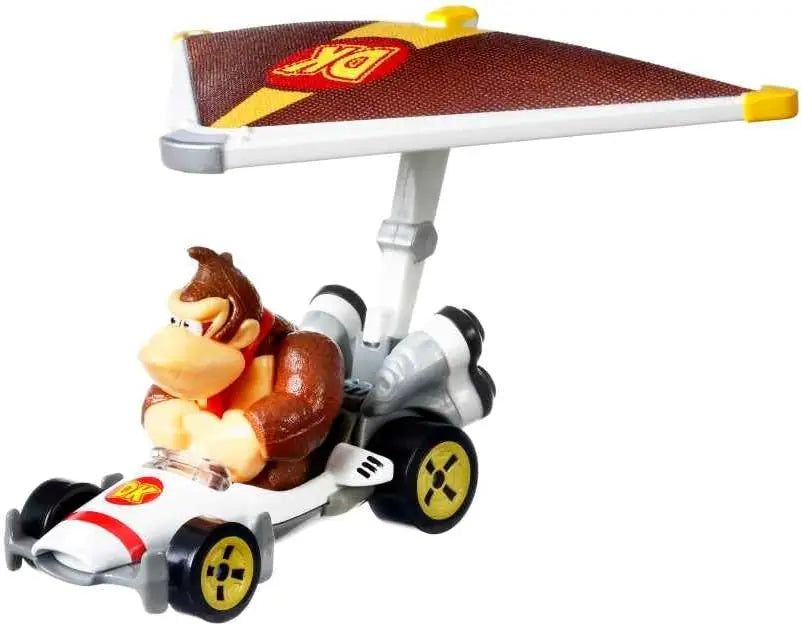 Donkey Kong in a white red and yellow Hot Wheels Mario Kart racing kart with silver thrusters and black wheels