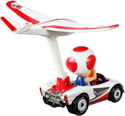White and red toad character in a white race car with red wings from hot wheels mario kart toad p-wing plane glider