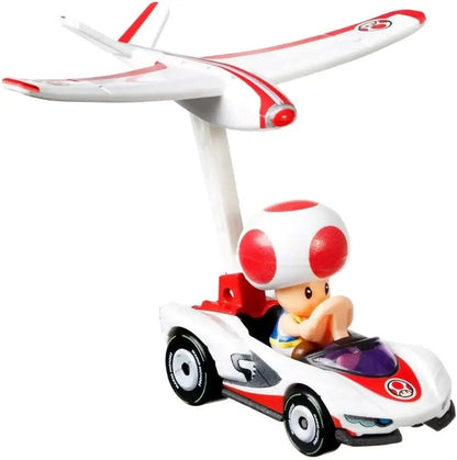 White and red plastic toad toy car with plane mounted above featuring mario kart design by hot wheels