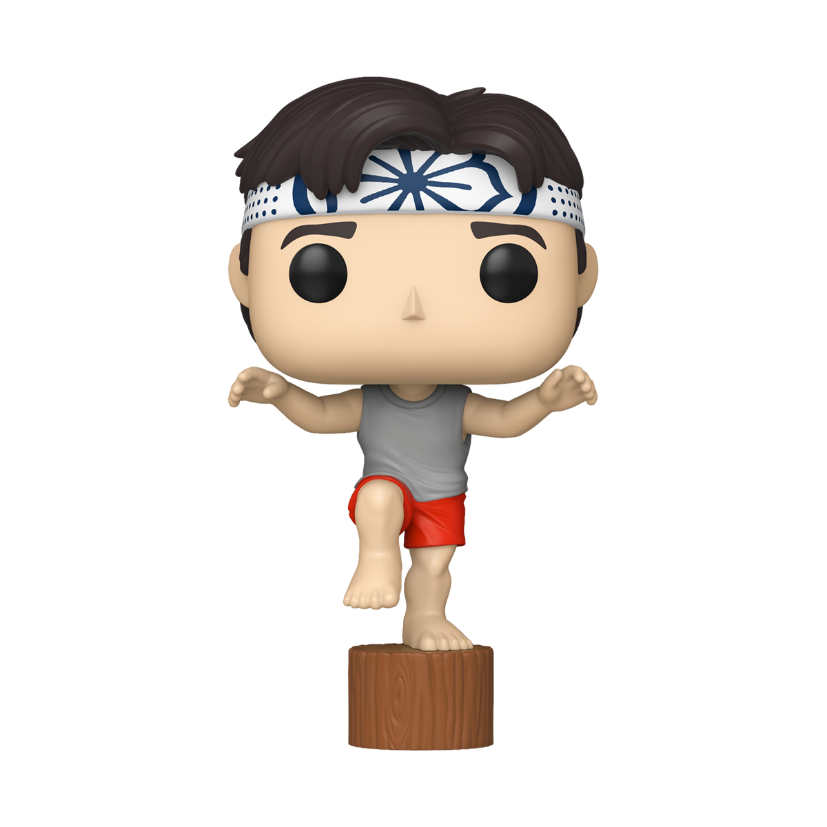 Karate Kid Daniel Crane Kick Funko Pop #2080 by Funko balancing on one leg on a wooden stump in his iconic pose.
