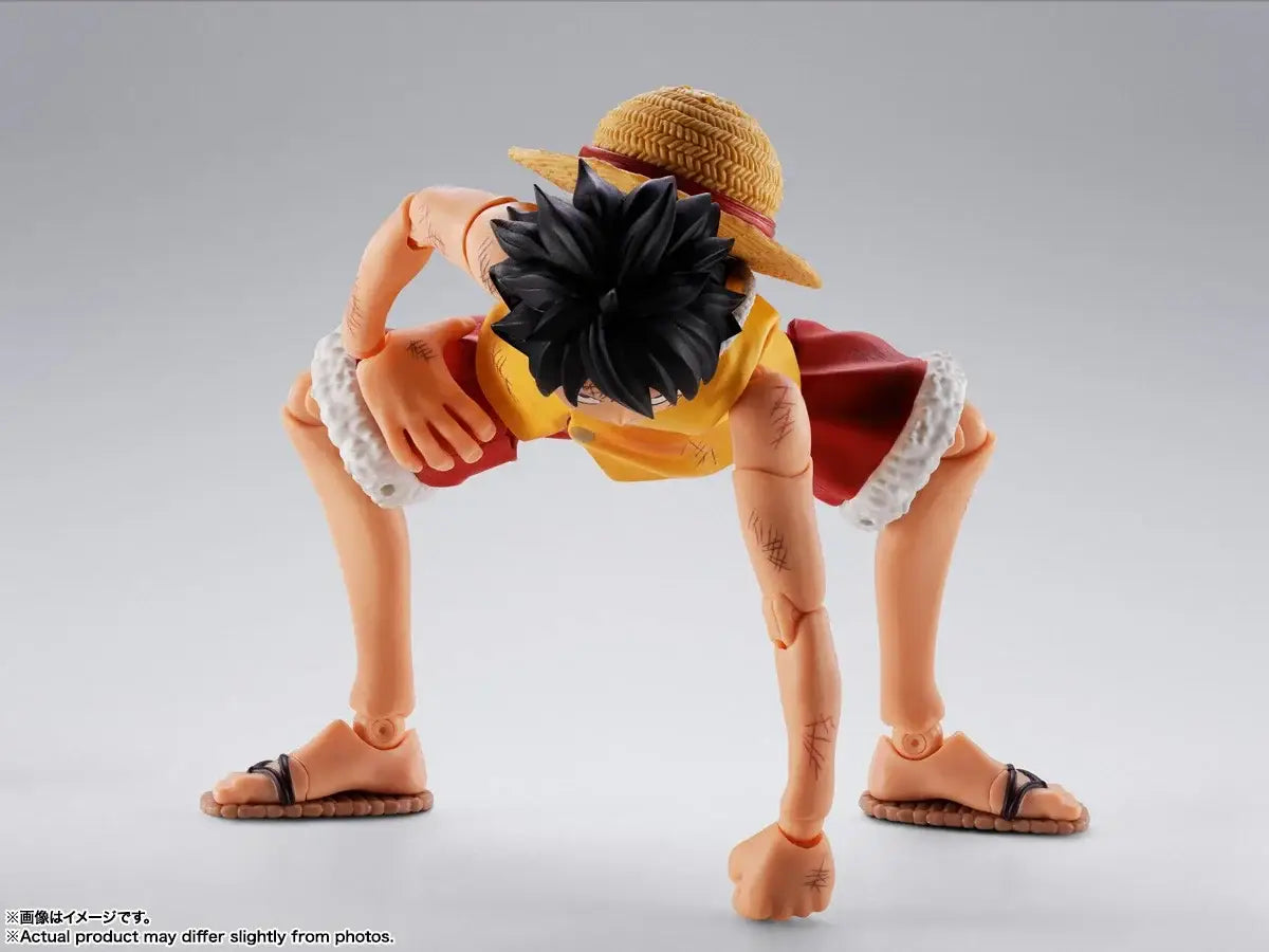 Monkey D Luffy Marineford figuarts action figure with orange skin, black hair, yellow shirt, red shorts, straw hat, and sandals