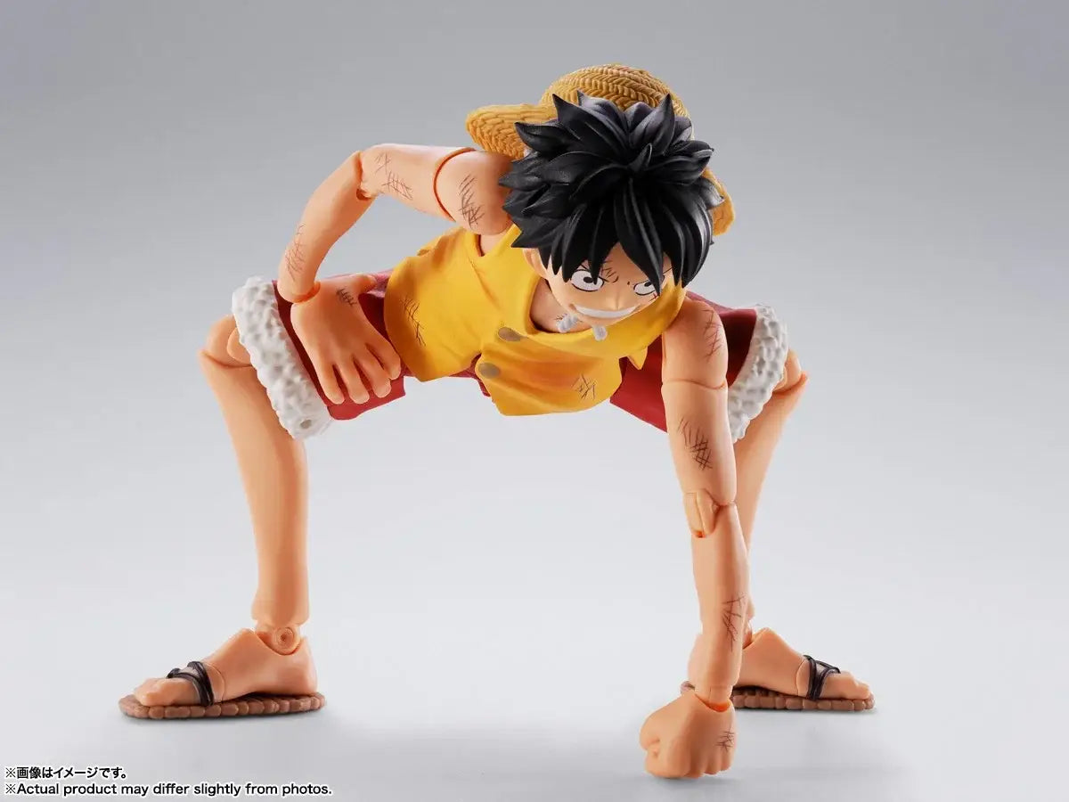 Monkey D Luffy Marineford figuarts action figure with orange skin, black hair, yellow shirt, and red shorts with white edges