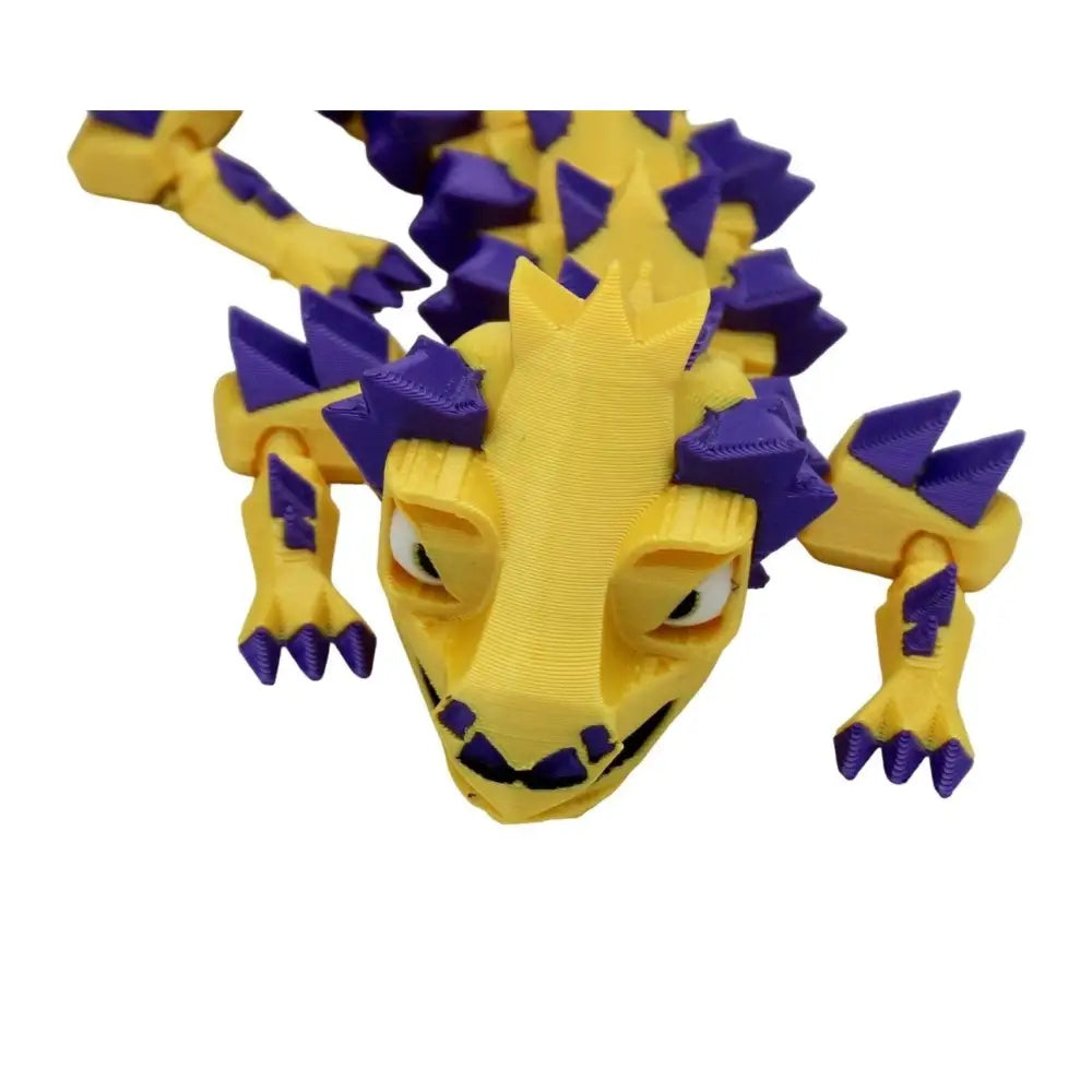 Yellow and purple 3D-printed dragon toy.
