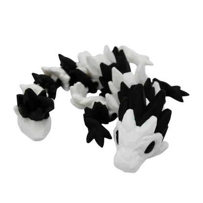 Black and white articulated dragon toy.