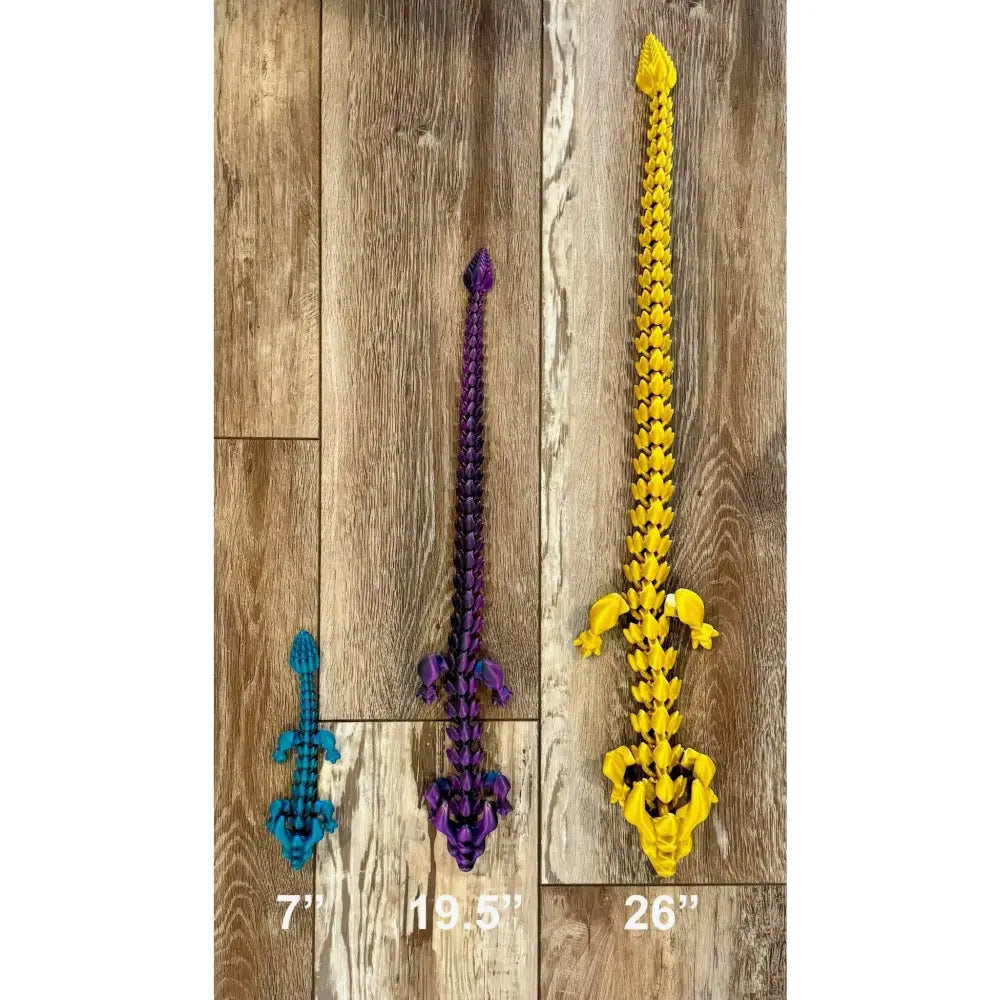 Three articulated dragon toys.