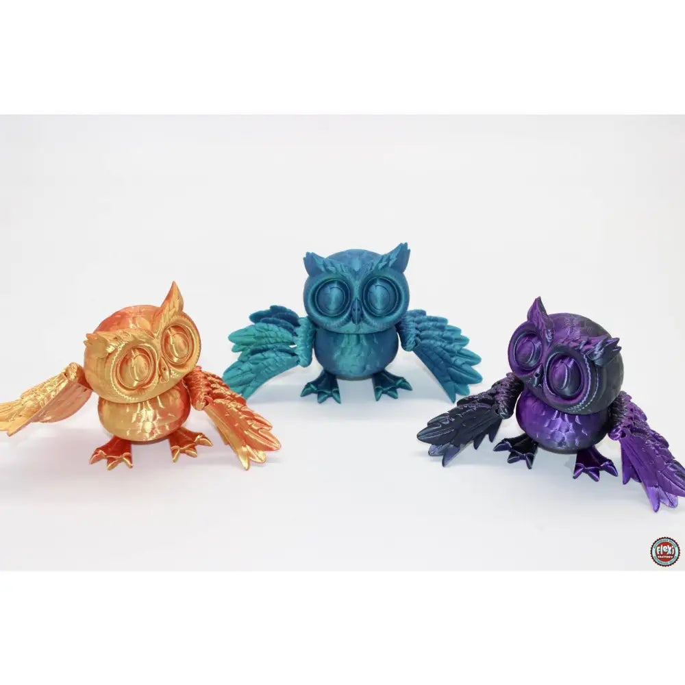 Three colorful 3D-printed owls.
