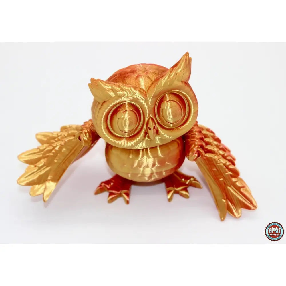 Golden 3D-printed owl figurine.