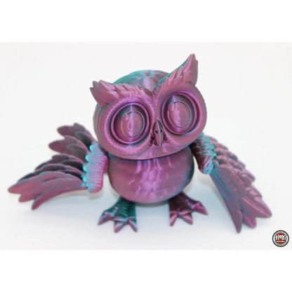 Iridescent purple and green owl figurine.