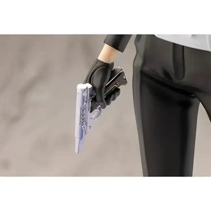 A translucent silver pistol with intricate detailing held in a black-gloved hand from persona 3 reload artfx statue