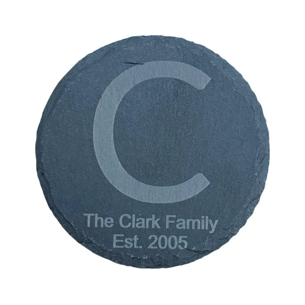 Round slate coaster with an etched initial and family name.