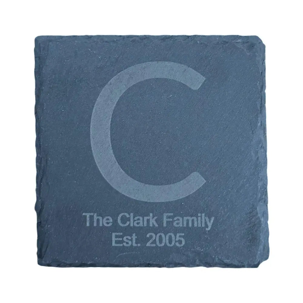 Square slate coaster with an etched initial and text.