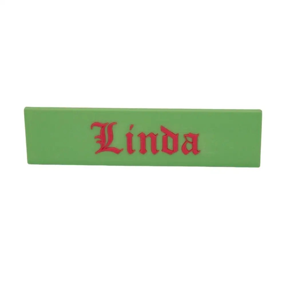 Green nameplate with red lettering.