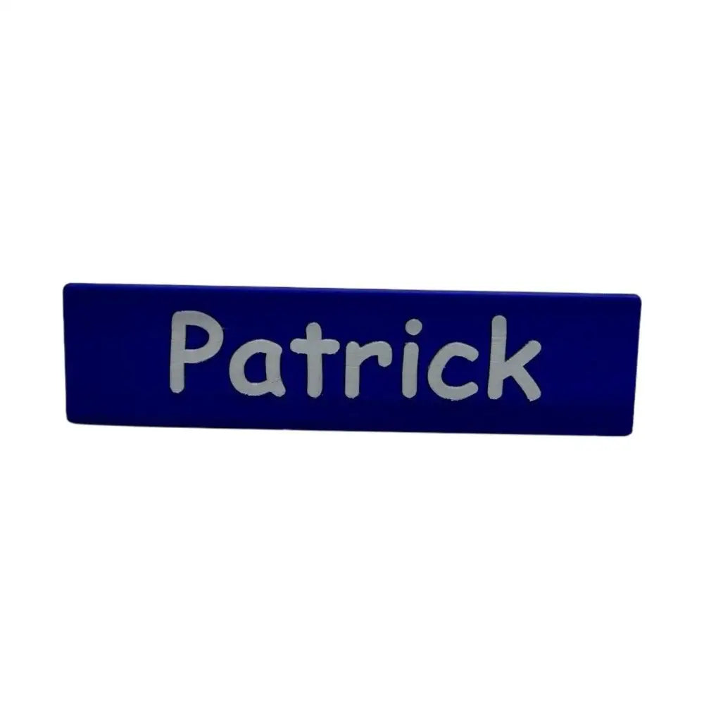 Blue nameplate with ’Patrick’ in silver.