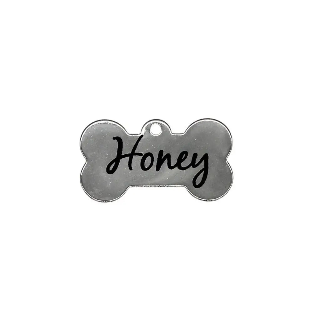 Silver dog bone tag with ’Honey’ written on it.