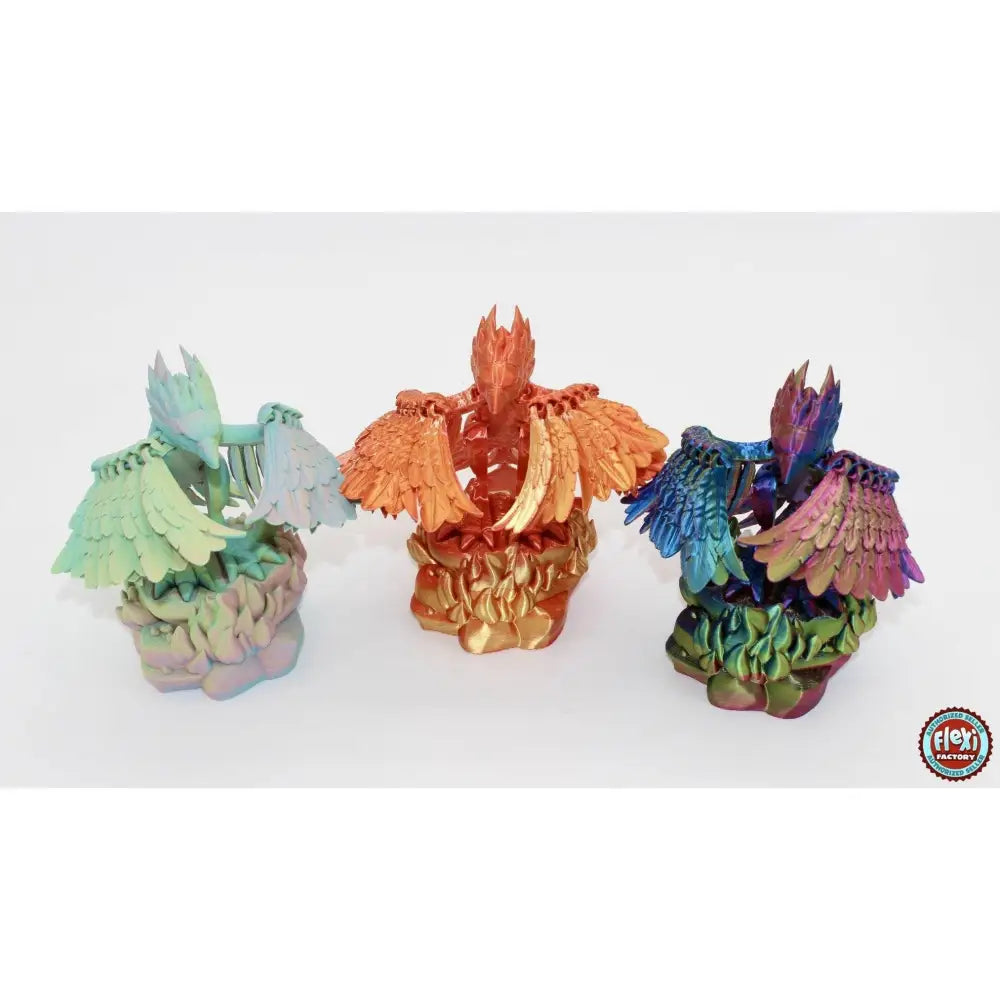 Three colorful phoenix figurines.