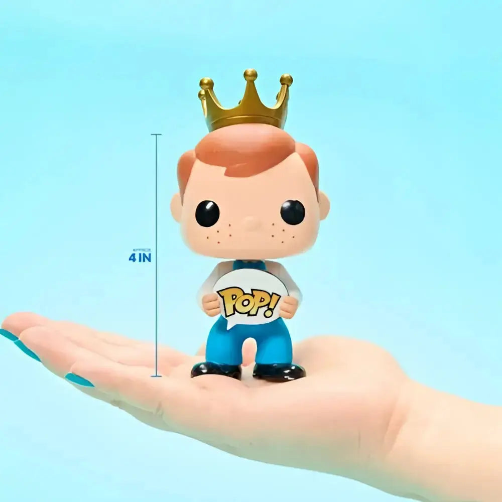 A golden crown on a reddish-brown haired vinyl figure holding a pop sign in the charizard funko pop vinyl figure