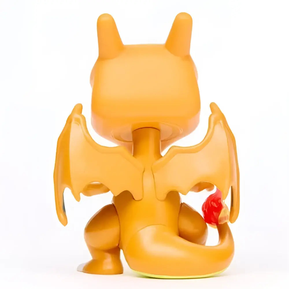 Orange plastic charizard funko pop vinyl figure with wings and red flame on tail collectible toy figure