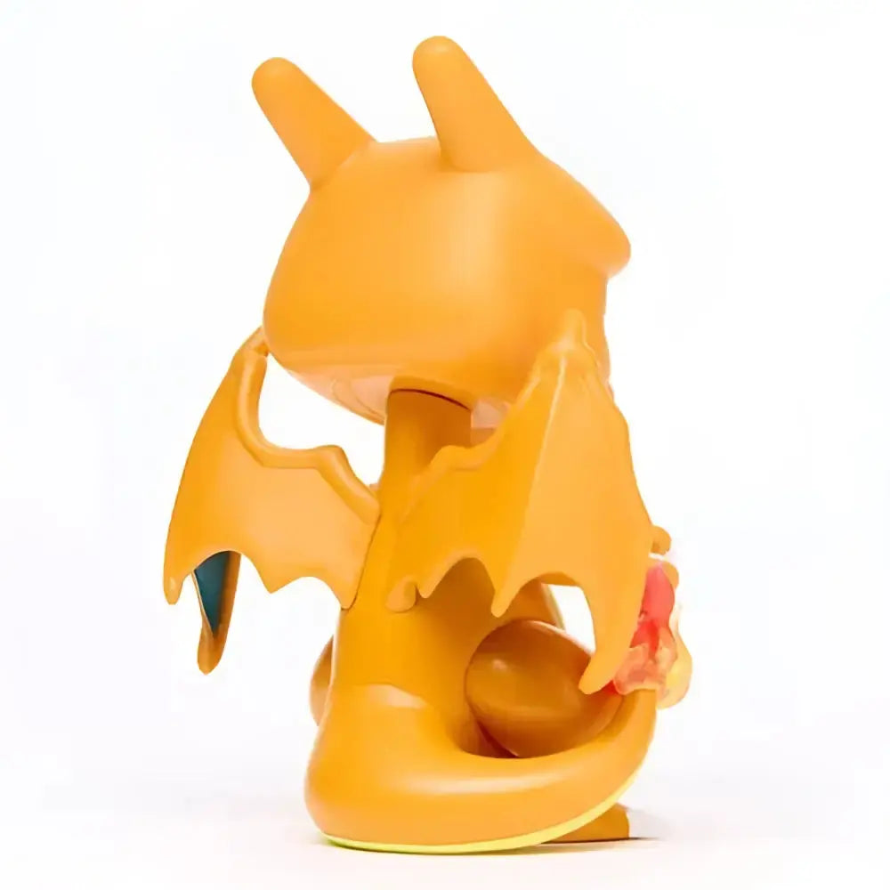 Orange plastic funko pop vinyl figure of charizard with wings pointed ears and tail from pokemon collection