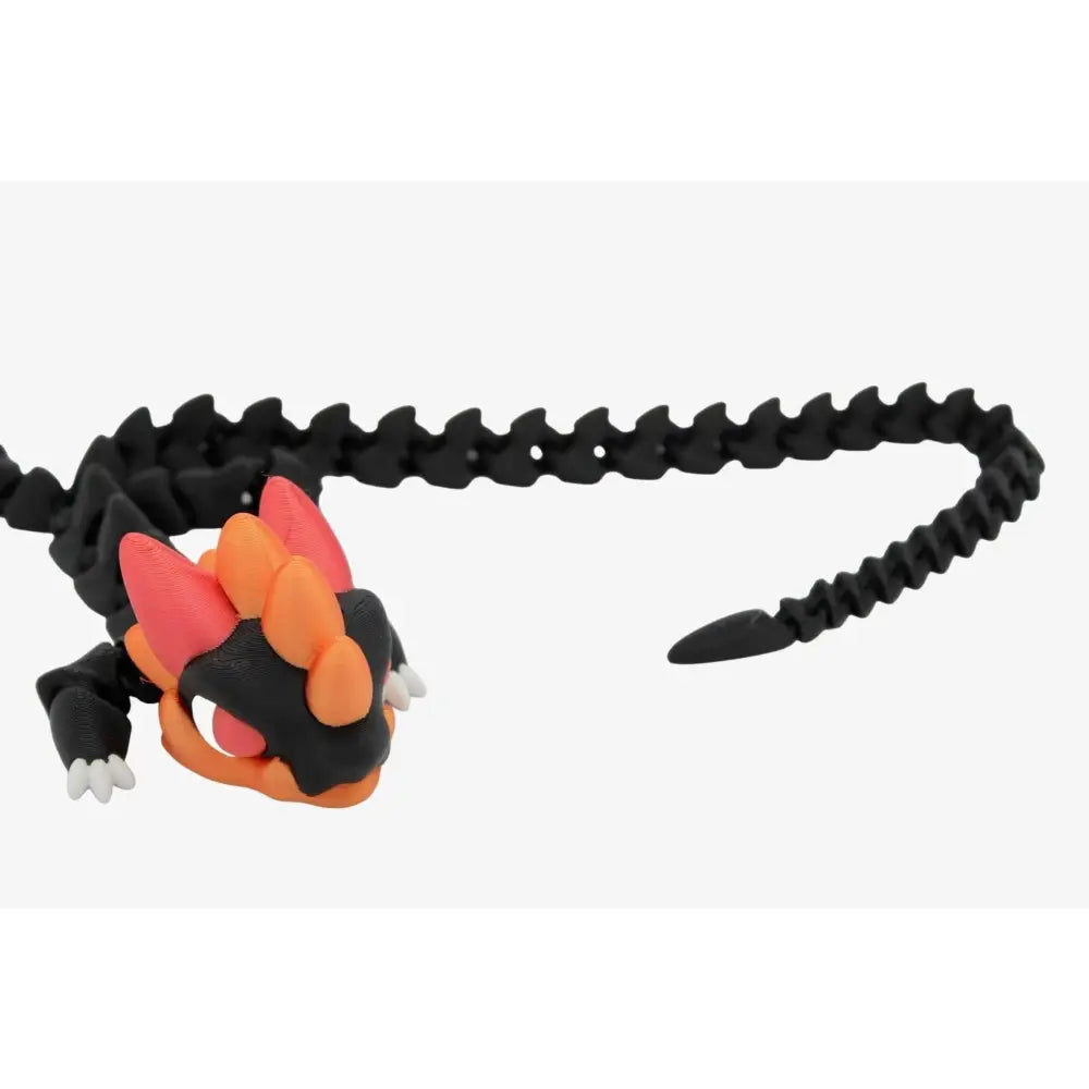 Articulated black and orange dragon toy.