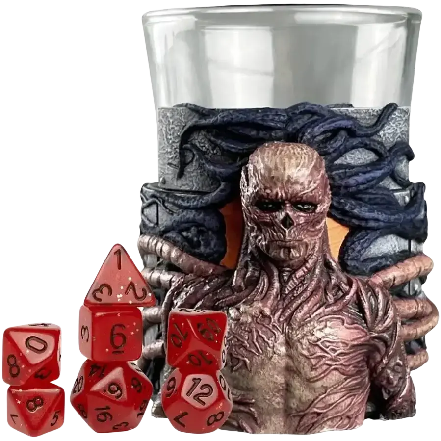 A translucent red polyhedral dice set with black numbering, displayed beside a glass container featuring a detailed sculpted figure of cthulhu.