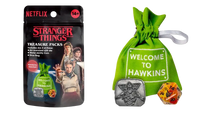Green ’welcome to hawkins’ dice bag with silver and orange die inside