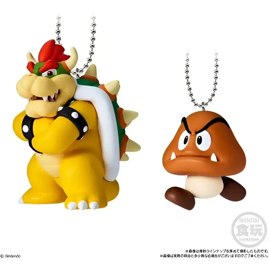 Yellow and green bowser figure with red hat and white shell spikes attached to silver chain from super mario bros mascot charm collection bandai shokugan