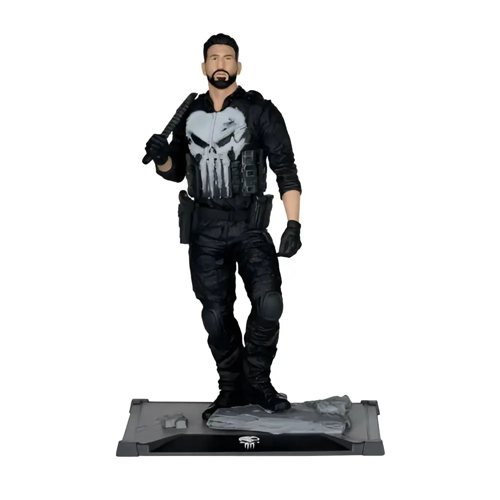 The punisher 1 10 scale posed figure features a black tactical gear action figure with a white skull emblem on a rocky base
