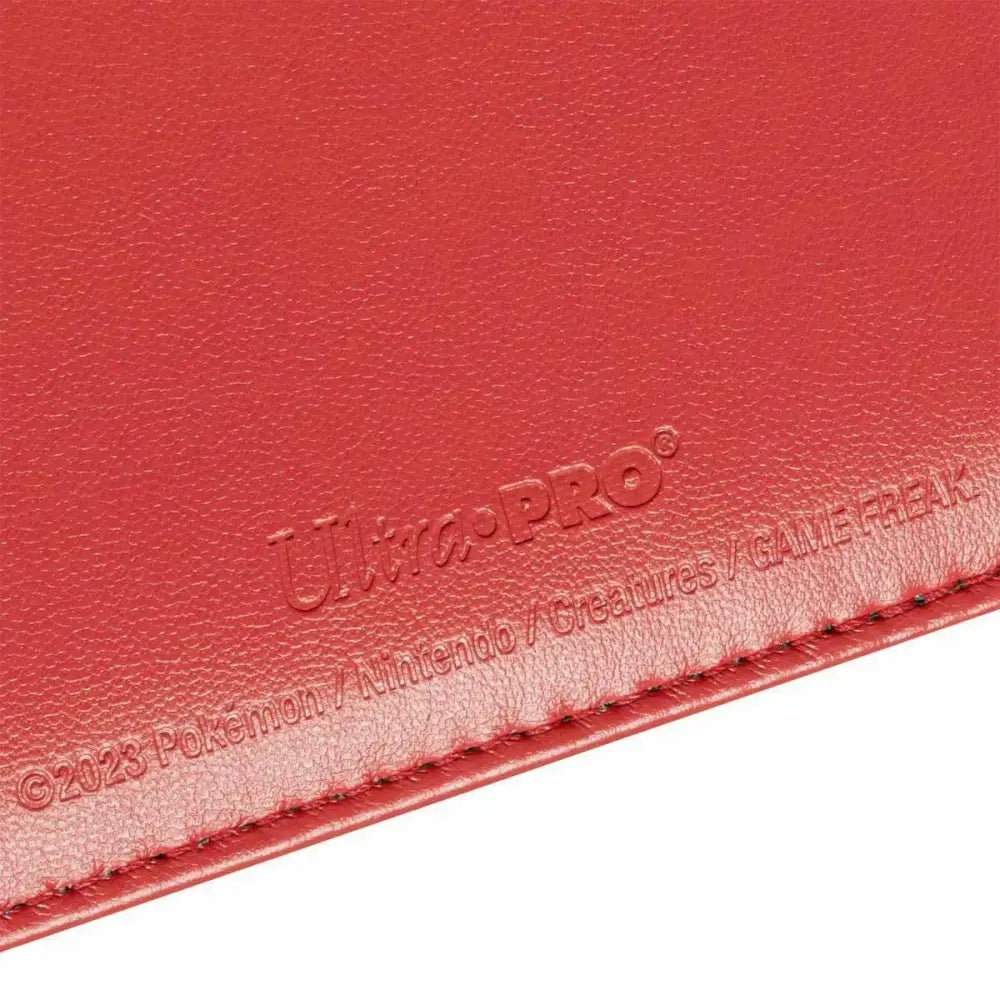 Red faux leather binder with embossed ’Ultra PRO’ and copyright text.