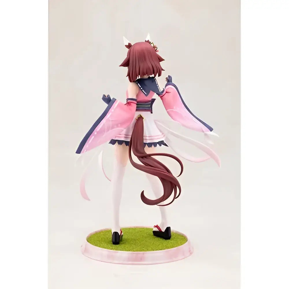 A 1 7 scale artfx statue of serena with reddish brown hair and small horns in a pink and white outfit on a green base