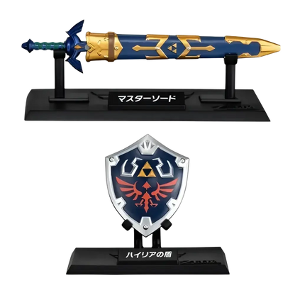 Blue and gold master sword with golden trident patterns and silver-edged hylian shield from bandai shokugan japan zelda weapon collection blind box mini