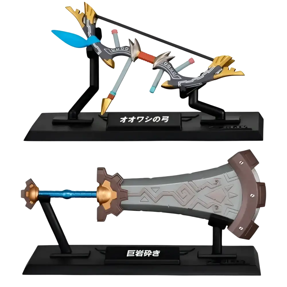 The ’ōō no tsukihime’ and ’ōyakashi’ sword figurines from the bandai gashapon collection, featuring detailed metallic finishes with gold accents on their hilts and blades.