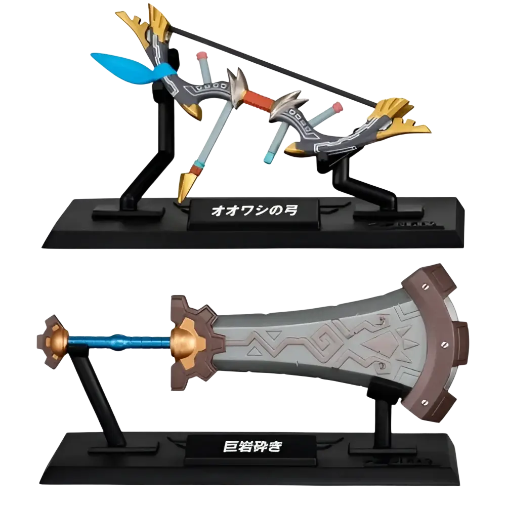 The ’ōō no tsukihime’ and ’ōyakashi’ sword figurines from the bandai gashapon collection, featuring detailed metallic finishes with gold accents on their hilts and blades.
