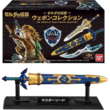 Blue and gold master sword figurine on black stand with japanese text from bandai shokugan japan zelda weapon collection blind box mini